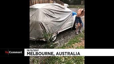 A man seeks shelter from "golf-ball" sized hailstones in Australia