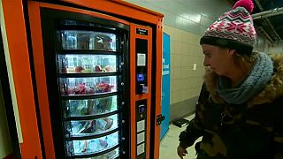 Homeless woman uses vending machine provided by charity