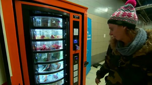 Homeless woman uses vending machine provided by charity Homeless woman uses vending machine provided by charity