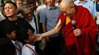 Tibetan spiritual leader, the Dalai Lama, speaks to students at a school in