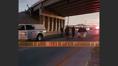 Rescuers attend to bodies that were hanged on the freeway to La Paz
