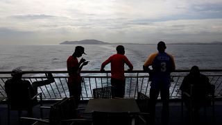 African migrant stand on board a ferry to Algeciras after having awaited