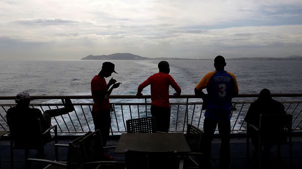 African migrant stand on board a ferry to Algeciras after having awaited African migrant stand on board a ferry to Algeciras after having awaited