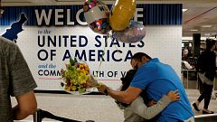 Ahmed Khalil hugs his daughters as they arrive at Washington 