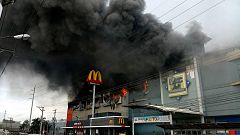 Smoke billows from a shopping mall on fire in Davao City