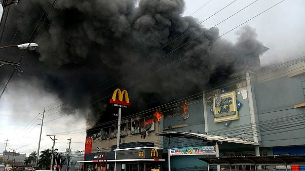 Smoke billows from a shopping mall on fire in Davao City Smoke billows from a shopping mall on fire in Davao City