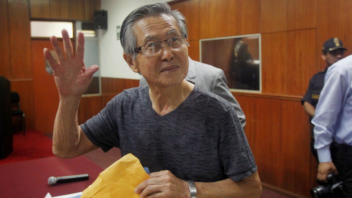 FILE PHOTO: Alberto Fujimori waves to the media in court 