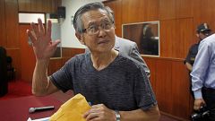 FILE PHOTO: Alberto Fujimori waves to the media in court 