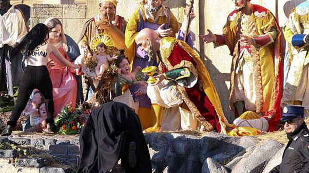 Topless Femen activist tries to snatch Jesus statue from Vatican crib Topless Femen activist tries to snatch Jesus statue from Vatican crib