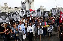 People holding pictures of victims of the guerrilla conflict