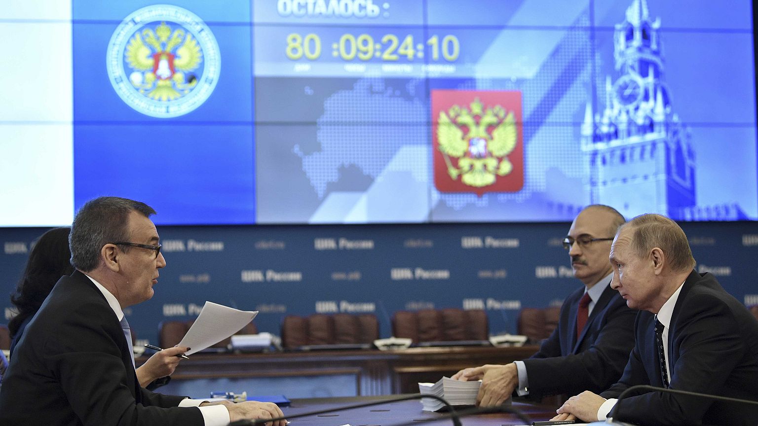 Russian President Vladimir Putin (R) visits the Central Election Commission