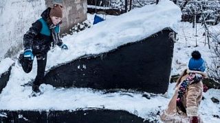 Anya, 13, plays with her sister in Avdiivka, eastern Ukraine