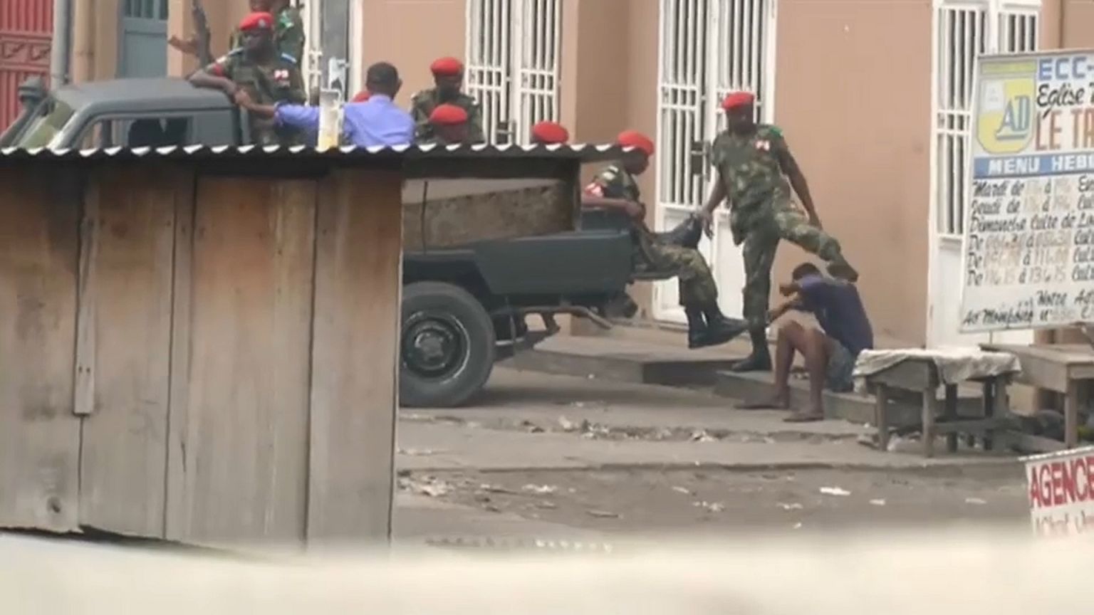 police kick protester