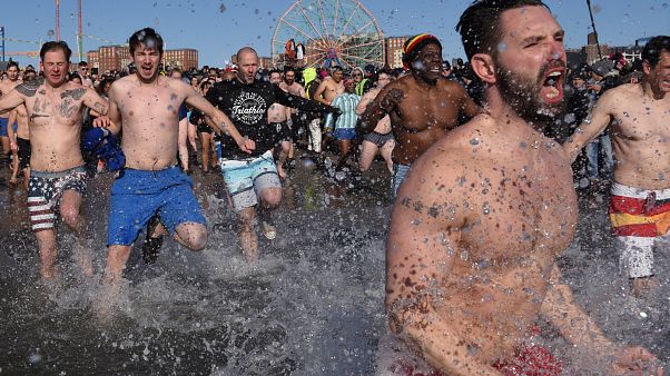 Thousands brave icy waters for New Year's plunge Thousands brave icy waters for New Year's plunge