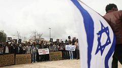 African migrants hold placard  protest outside Israel Supreme Court
