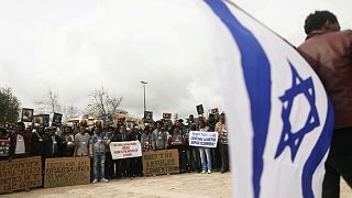 African migrants hold placard  protest outside Israel Supreme Court