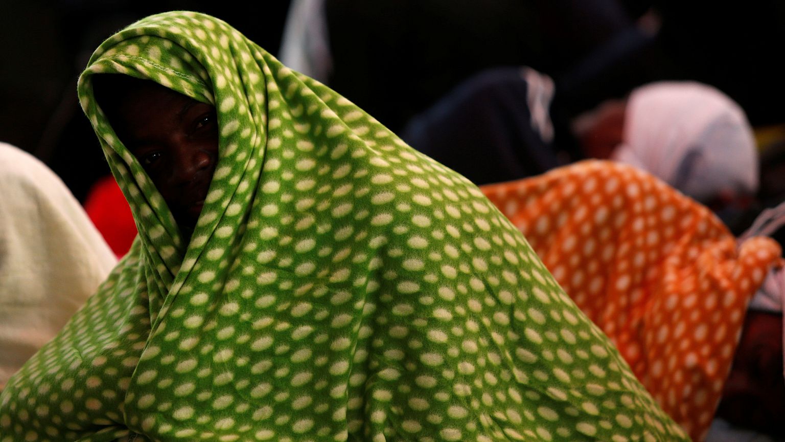 Migrants rest on the MV Aquarius, a search and rescue ship...