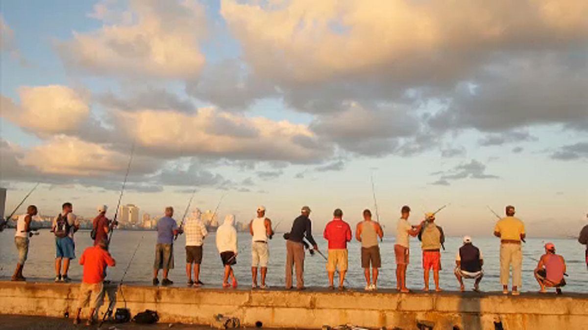 People fish along Havana's Malecon seafront. 