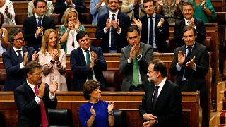 Spanish Prime Minister Mariano Rajoy receives applause from his party