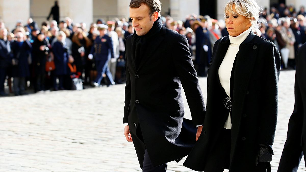 الرئيس الفرنسي ايمانويل ماكرون وزوجته بريجيت الى جانبه