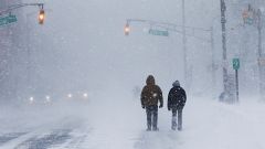 People struggle against wind and snow at the Jersey shore in Long Branch NJ