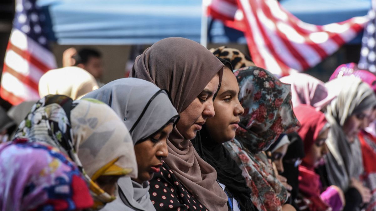 Women participate in a group prayer in New York City