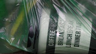 A disposable coffee cup is seen in a refuse bag in London, UK