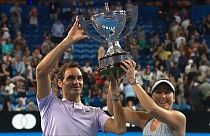 Roger Federer and Belinda Bencic hold aloft the Hopman Cup for Switzerland