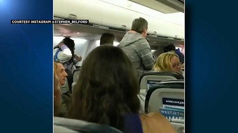 Passengers scramble to emergency exits 