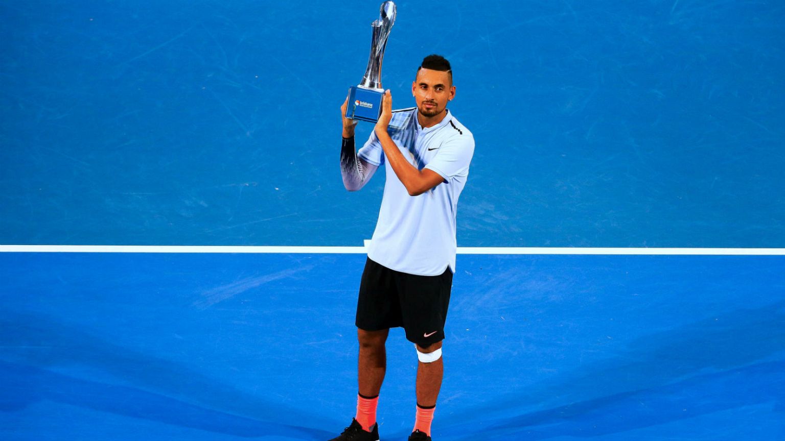 Nick Kyrgios holds aloft Brisbane International title 
