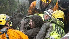  Emergency personnel carry a woman rescued from a collapsed house in USA