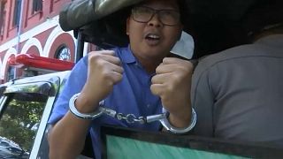 Reuters journalist Wa Lone on the way to court in handcuffs,