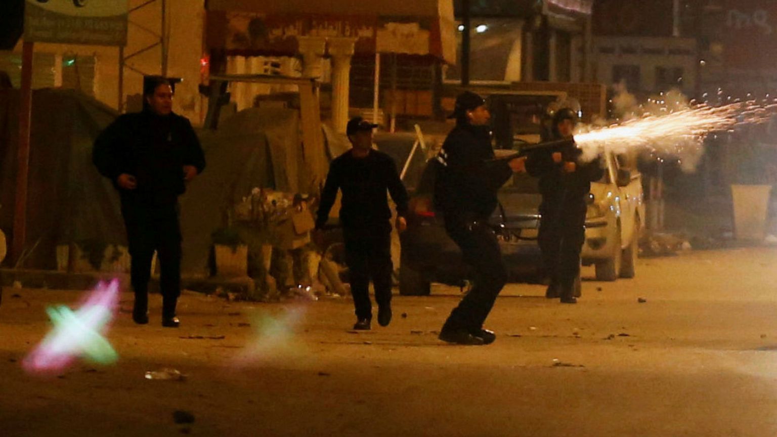 Police officers fire tear gas