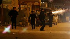 Police officers fire tear gas