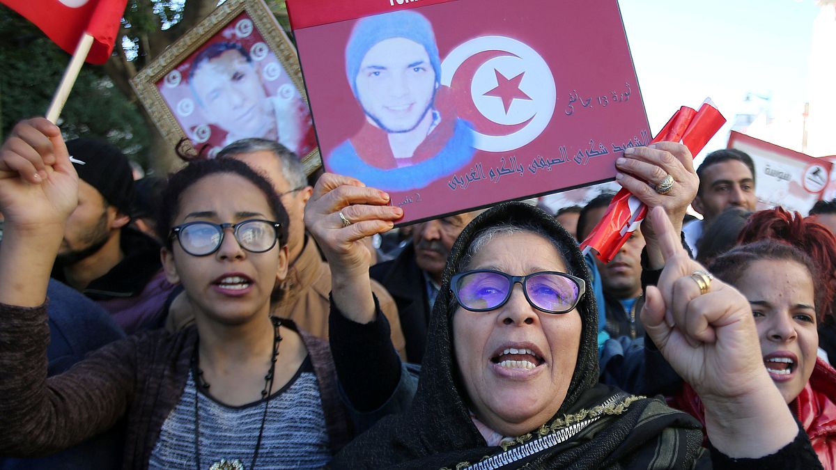 People attend demonstrations on the seventh anniversary of revolution  