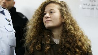 Palestinian teen Ahed Tamimi enters a military courtroom at Ofer Prison