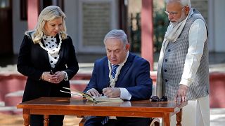 Israeli Prime Minister Netanyahu writes a message in the visitor's book
