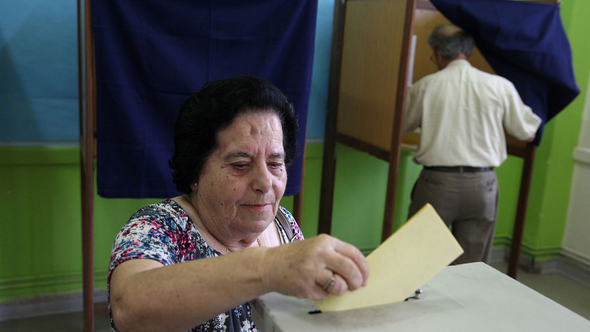 A woman casts her vote at a polling station during parliamentary elections 