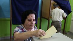 A woman casts her vote at a polling station during parliamentary elections 