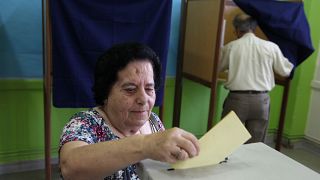 A woman casts her vote at a polling station during parliamentary elections