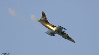 A Syrian Air Force fighter plane fires a rocket during an air strike in the