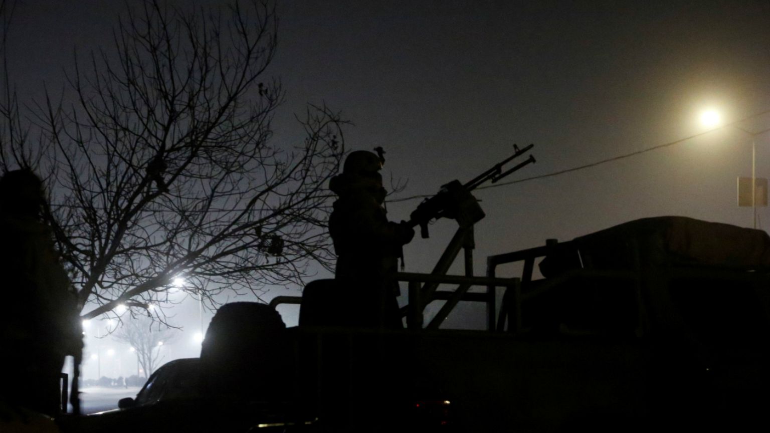 A member of the Afghan security keeps watch near the Intercontinental hotel