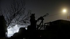 A member of the Afghan security keeps watch near the Intercontinental hotel