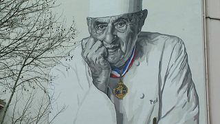 Paul Bocuse looks down fondly on Lyon from mural outside Les Halles
