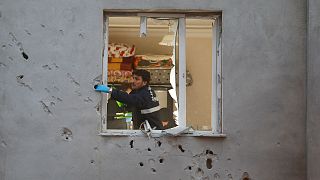 Turkish police examine house hit by shelling from Syria 