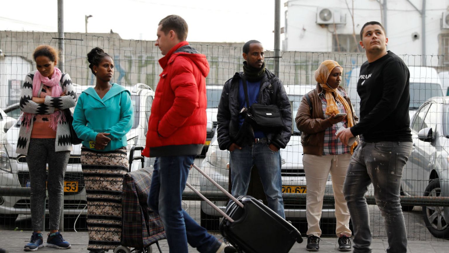 People wait at a bus station in south in Tel Aviv