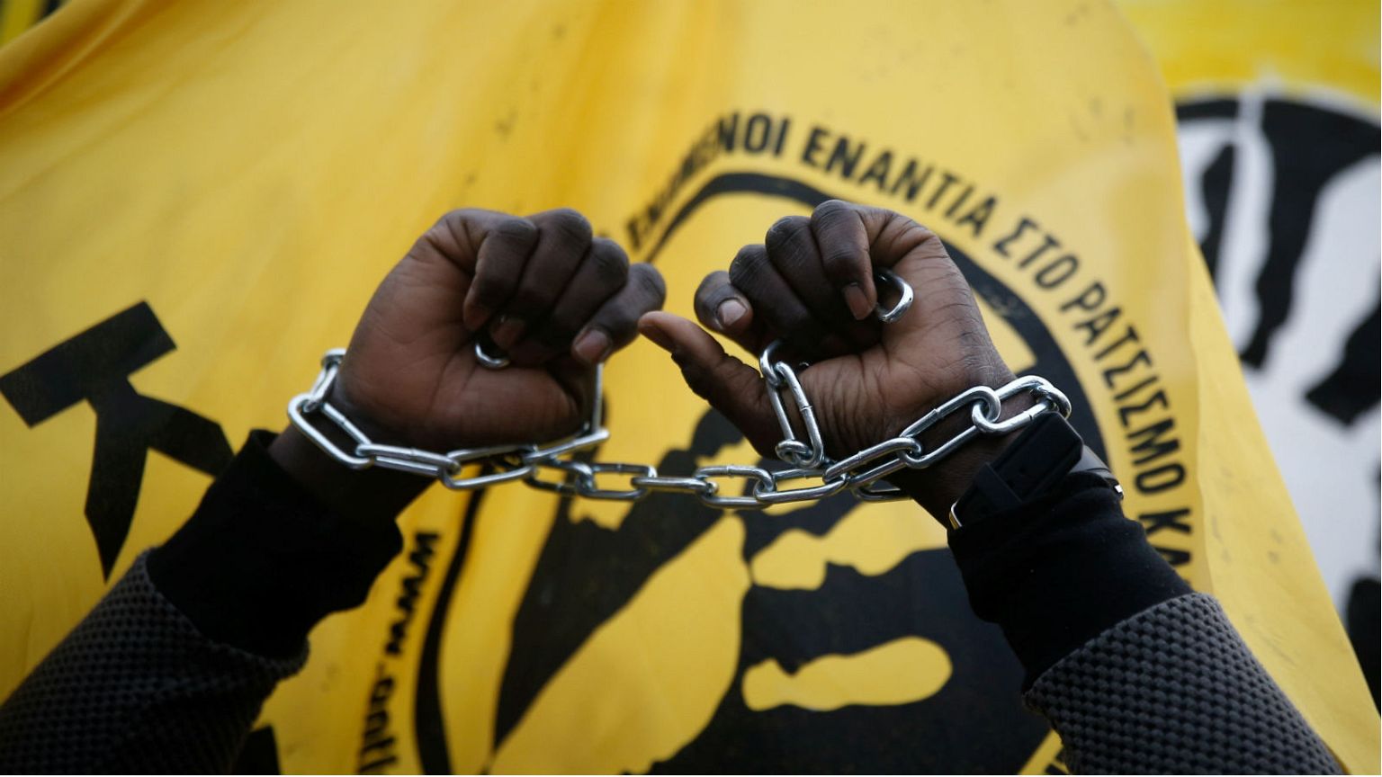 A migrant living in Greece protests reports of migrant slavery in Libya