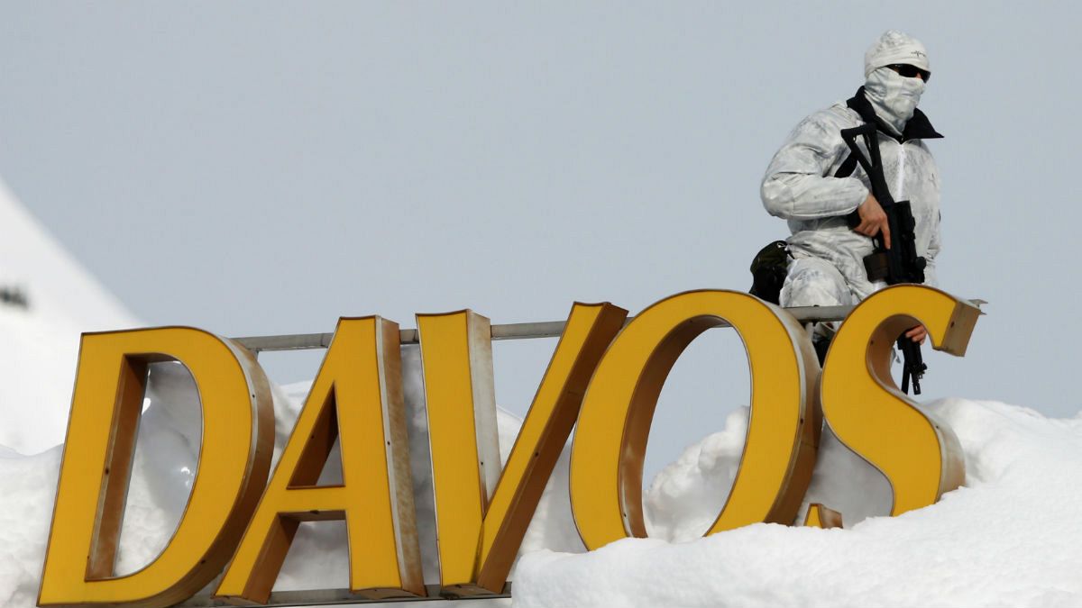 Swiss police officer observes surrounding area from roof Davos 