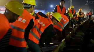 Full steam ahead: Chinese workers lay new railway track in just hours