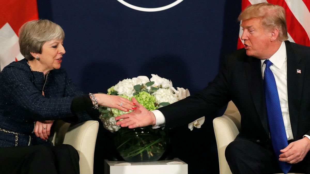 US President Trump shakes hands with UK Prime Minister Theresa May in Davos